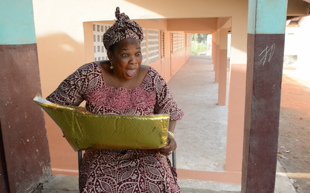 A surprised Mariama Bangoura receiving her very first computer.